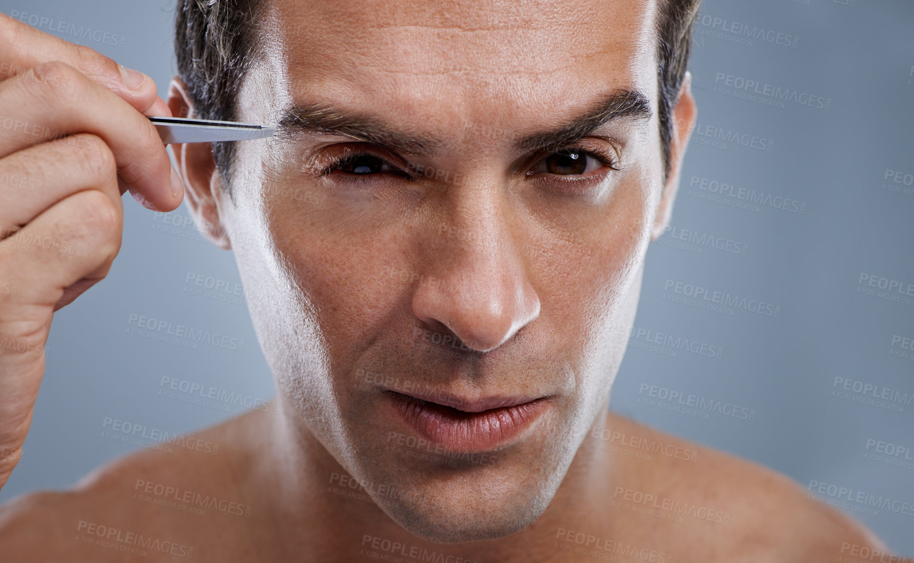 Buy stock photo Man, portrait and tweezers for eyebrows or grooming for face clean, hygiene or grey background. Male person, pluck and hair removal for healthy morning routine or studio, treatment or mockup space