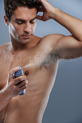 Buy stock photo Man, deodorant and spray for armpit odor in studio or product application for clean smell, hygiene or grey background. Male person, topless and confidence or health wellness, care or mockup space