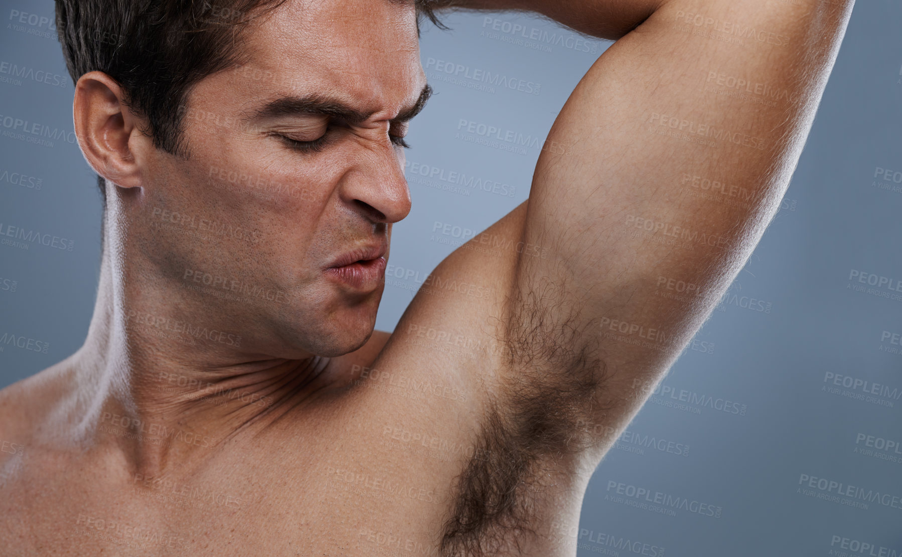 Buy stock photo Armpit, stink and man with sweat, poor hygiene and routine on grey studio background for deodorant, cleaning and skincare. Underarm, bad smell and model with hyperhidrosis, body odor or cosmetics