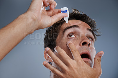 Buy stock photo Man, eye drops and vision for allergies care in studio or healthcare wellness, liquid or grey background. Male person, solution and conjunctivitis dropper for clean pupil or dry, irritation or mockup