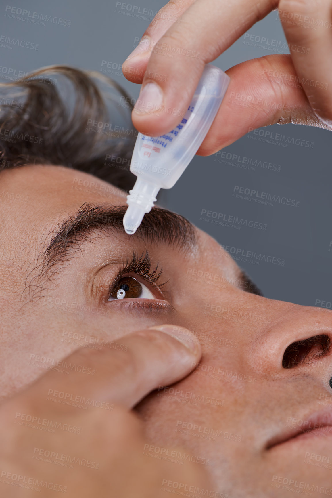 Buy stock photo Man, eye drops and vision for allergies or treatment in studio or healthcare wellness, dropper or grey background. Male person, solution and conjunctivitis for clean pupil or pain, liquid or apply