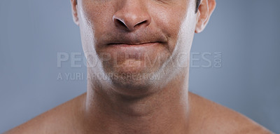 Buy stock photo Man, mouth and face with clean shave, facial hygiene and upset  with cosmetic treatment closeup. Grooming, mockup space and skincare with young male model in studio background with epilation