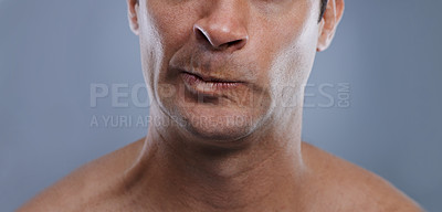 Buy stock photo Man, mouth and angry with shave, face and hygiene with skincare, upset, and frustrated with treatment closeup. Grooming, mockup space and moody with male model in studio background with cosmetics
