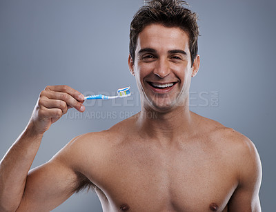 Buy stock photo Portrait, man and smile with toothbrush, dental hygiene and body care on grey studio background. Face, person and model with fresh breath and healthy with toothpaste and morning routine with wellness