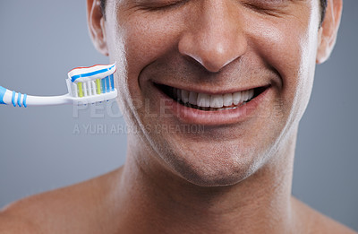 Buy stock photo Closeup, toothbrush and man with a smile, clean and wellness on grey studio background. Happy, person and model with dental hygiene or oral health with fresh breath or toothpaste with morning routine
