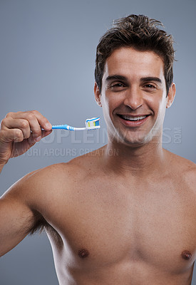 Buy stock photo Portrait, man and smile with toothbrush, oral health and body care on grey studio background. Face, person or model with fresh breath or healthy with toothpaste or morning routine with dental hygiene