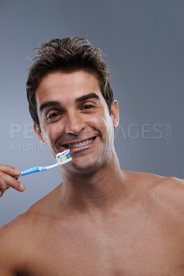 Buy stock photo Portrait, toothbrush and man with a smile, clean and morning routine on grey studio background. Happy, person or model with dental hygiene or oral health with fresh breath or toothpaste with wellness