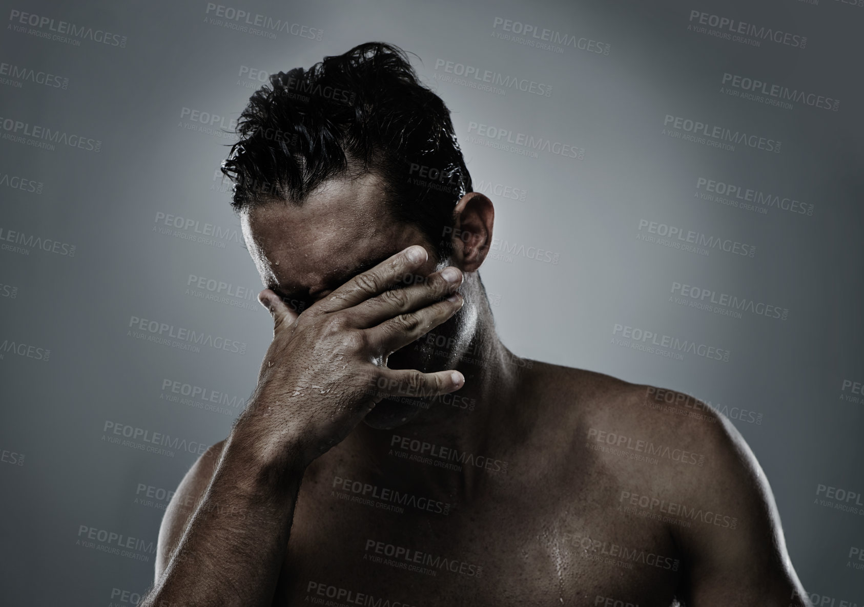 Buy stock photo Man, hand and face hiding in studio for embarrassed shame on grey background or topless, unhappy or mockup space. Male person, model and fingers for bad decision or fail mistake, palm or distress