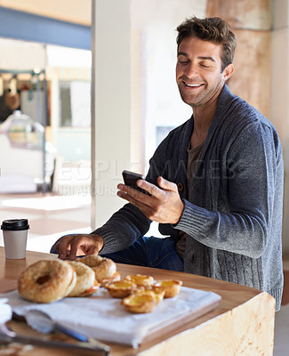 Buy stock photo Phone, smile and man with breakfast at restaurant networking on social media, mobile app or internet. Happy, food and young male person scroll on cellphone with healthy meal at cafe or coffee shop.