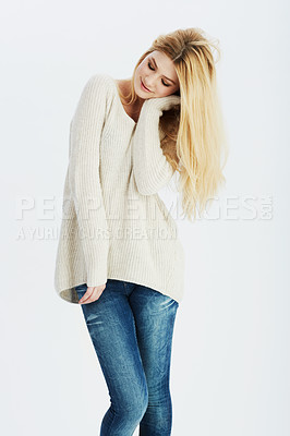 Buy stock photo Winter fashion, happy and woman shy in studio on white background for casual clothing style. Model, smile and wool sweater with young blonde girl in denim jeans clothes for cold season weather
