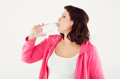Buy stock photo Woman, fitness and drinking water for hydration after workout or exercise on a white studio background. Female person or plus size and mineral drink in natural wellness on break or mockup space