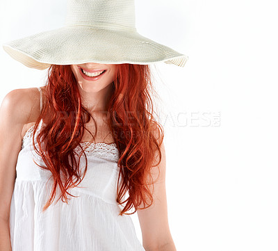 Buy stock photo Happy woman, fashion and hiding with hat in studio, white background and isolated mockup. Hidden face, mystery style and female model smile with red hair, cool summer accessory and elegant beauty