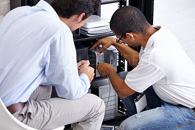 Buy stock photo A technician fixing his client's electronic device