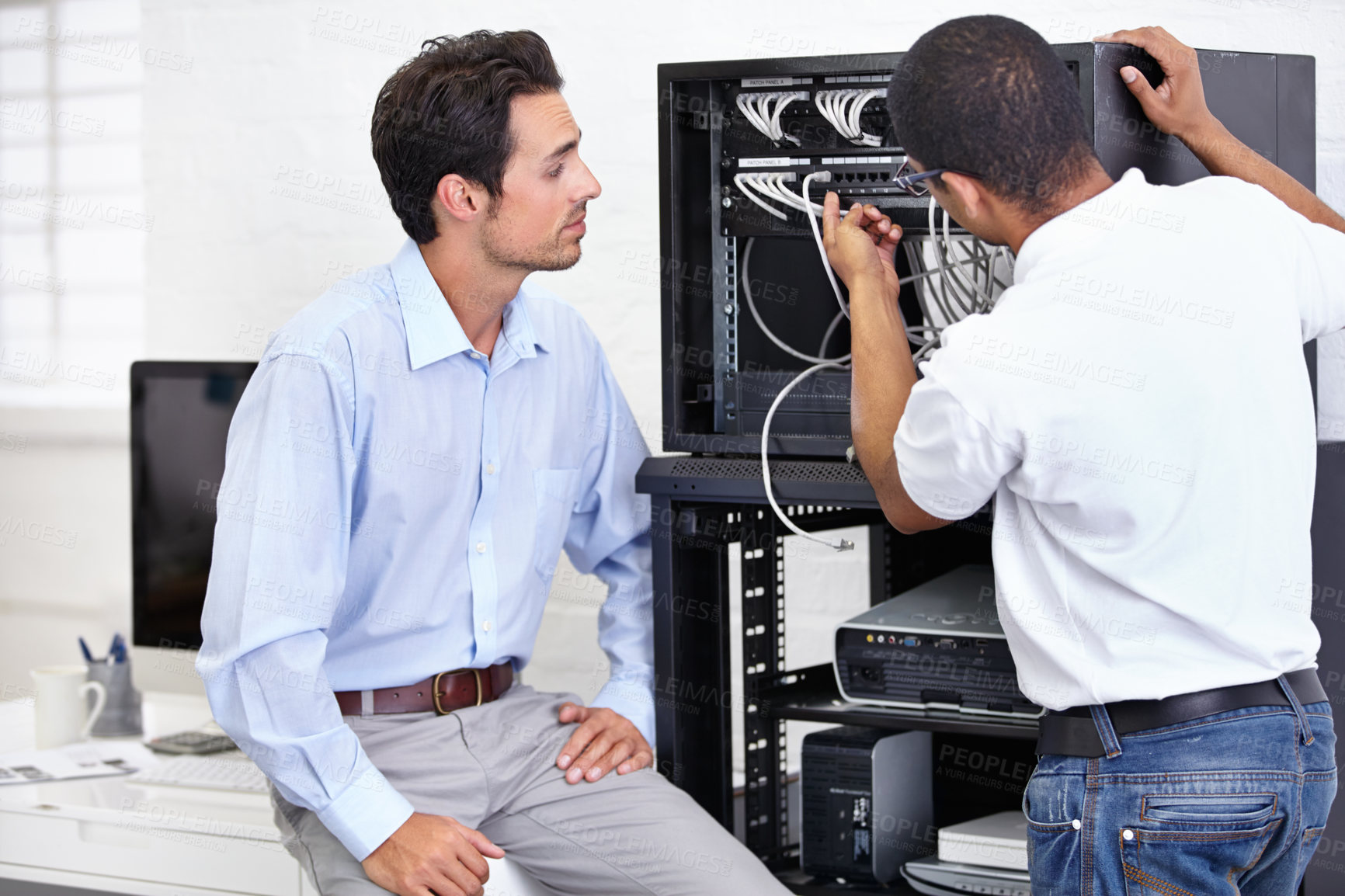 Buy stock photo Server room, man or technician with working on hardware maintenance after glitch in business office. Network, tech support or worker with electrician or electrical engineer for information technology
