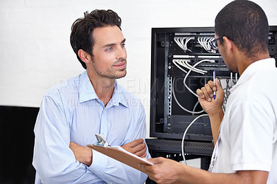 Buy stock photo Server room, man or technician speaking of software maintenance after glitch in business office. Network, tech support or worker with electrician or electrical engineer for information technology