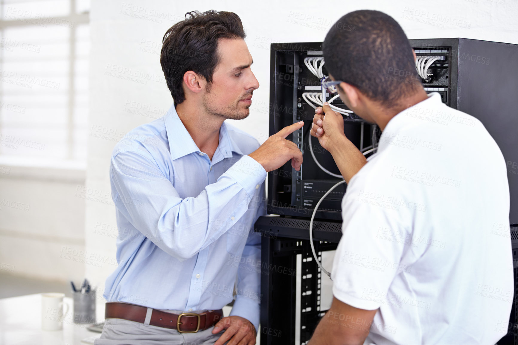 Buy stock photo Server room, it support and pointing with a technician talking to a business man about cable connectivity. Network, database and consulting with an engineer showing a male employee a wired connection