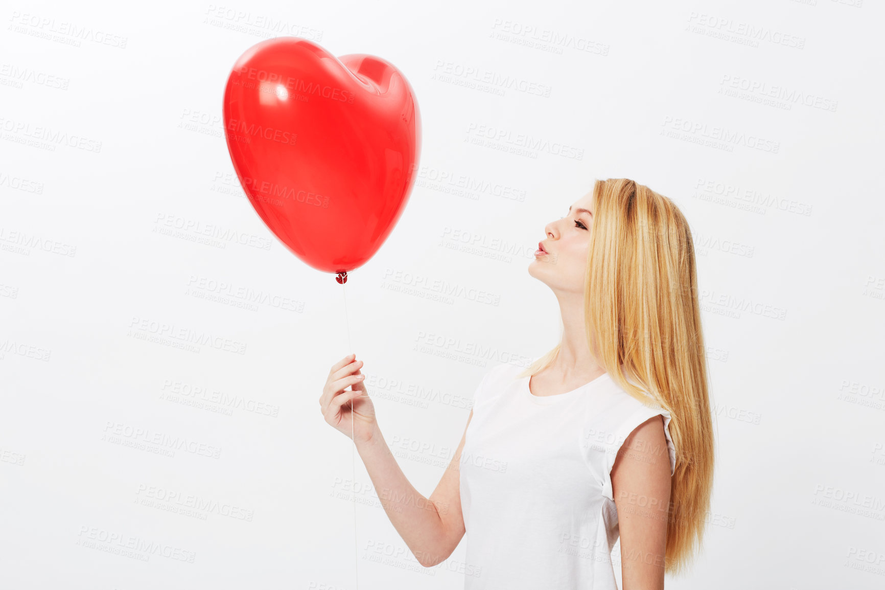 Buy stock photo Studio, heart and balloon with a profile of woman on valentines day isolated on white background. Love, red shape and female person holding a gift or present with romance, emotion or passion for fun