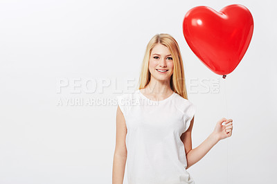 Buy stock photo A gorgeous young blonde woman holding a heart while isolated on a white background