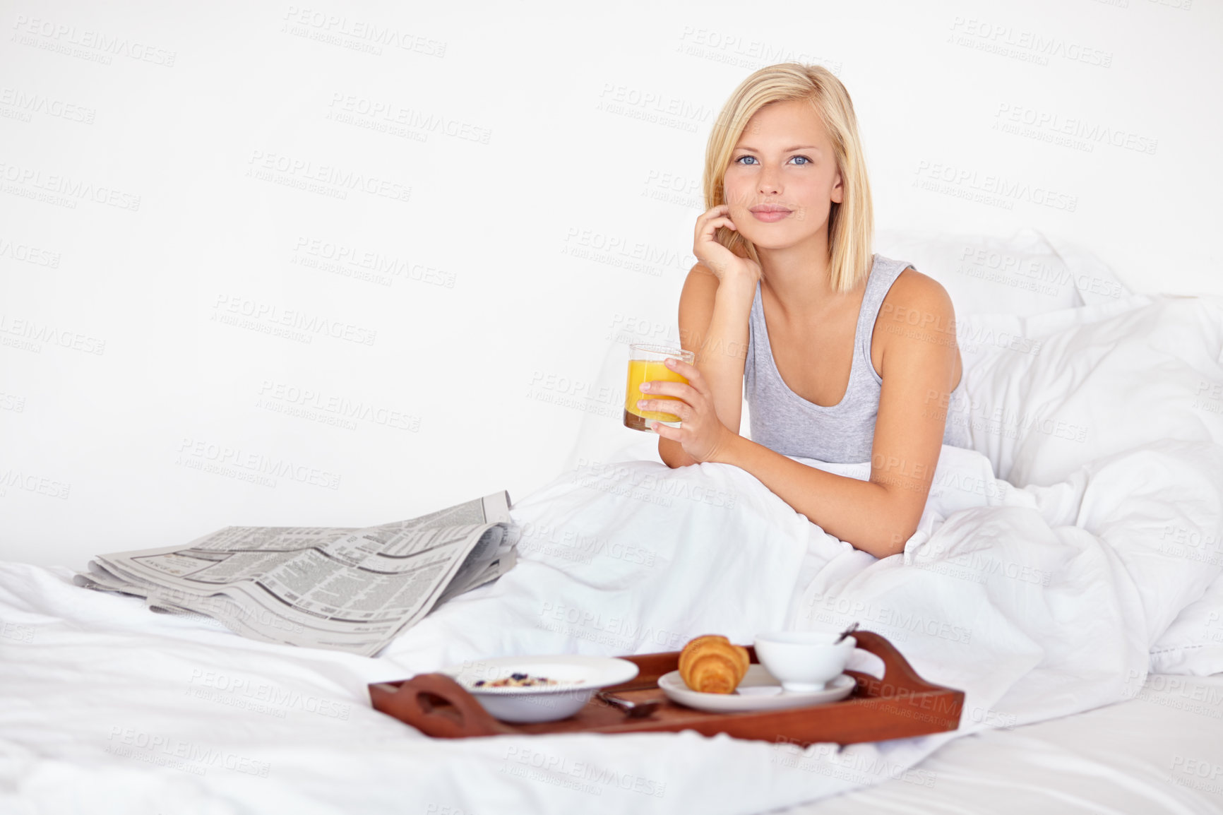 Buy stock photo Healthy, breakfast and portrait of woman in bed with food, orange juice and relax with newspaper. Calm, girl and eating in bedroom on vacation with croissant, brunch and glass with drink in home