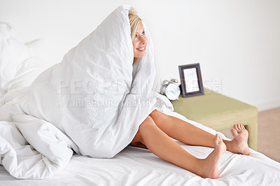 Buy stock photo Shot of a smiling woman covered in a duvet lying on her bed
