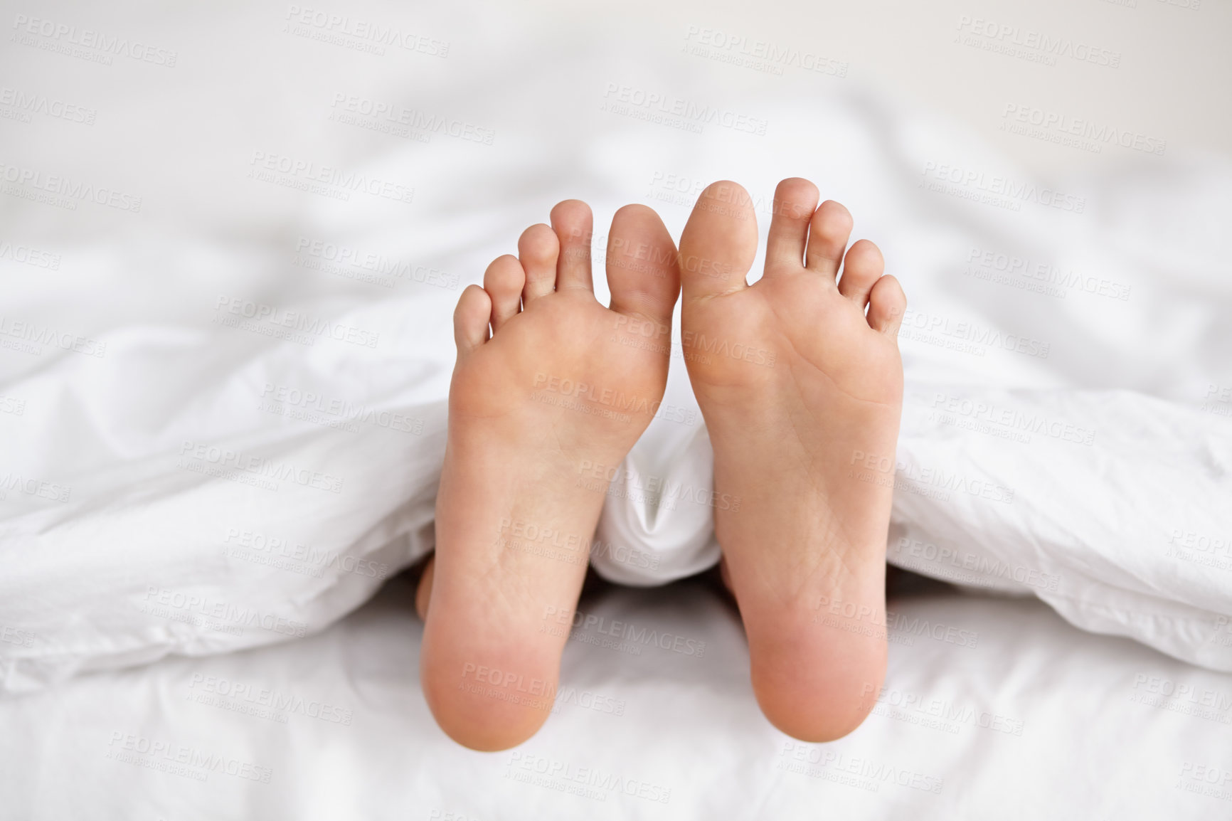 Buy stock photo Bed, feet and person sleeping in home, relax and resting nap in sheets for health, calm and leisure in the morning. Foot, bedroom and closeup of toes in blankets, skin of legs and comfort in house