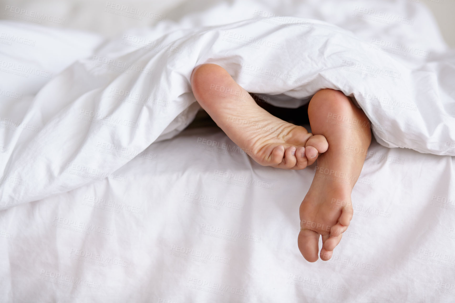 Buy stock photo Bed, feet and person sleeping in home, relax and resting nap in sheets for health, calm and leisure in the morning. Foot, bedroom and closeup of toes in blanket, skin of legs and comfort in house