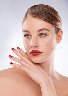 Buy stock photo Portrait of an attractive young woman wearing bright red lipstick and nail polish
