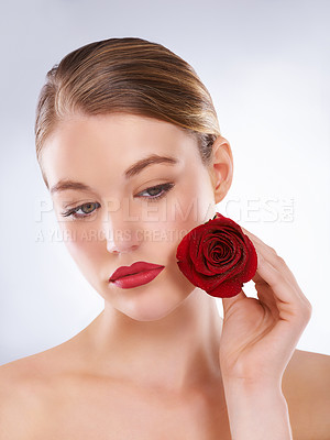Buy stock photo Face, rose and red lipstick makeup with woman in studio on gray background for cosmetology. Beauty, aesthetic and flower with confident young model at salon or spa for natural cosmetic makeover
