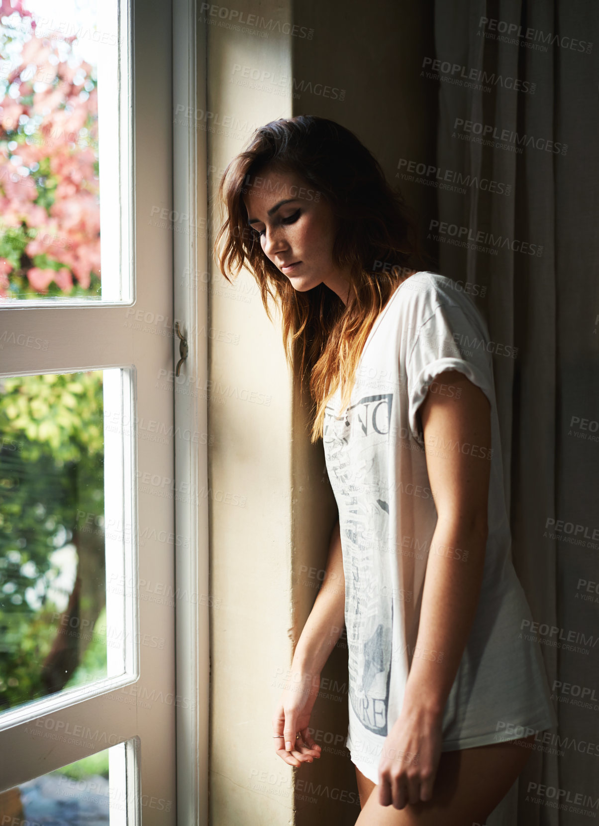 Buy stock photo Thinking, depression and serious woman by window in home, lonely or mental health anxiety. Dream, stress and sad young person with worry for mistake, frustrated in crisis or remember memory of trauma