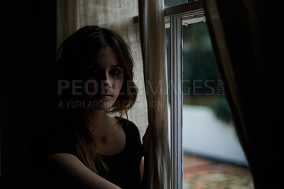 Buy stock photo Woman, portrait and relax by window at night in dark room in stress, anxiety or mental health and lonely at home. Young female person sitting by glass at house with insomnia in neighborhood apartment