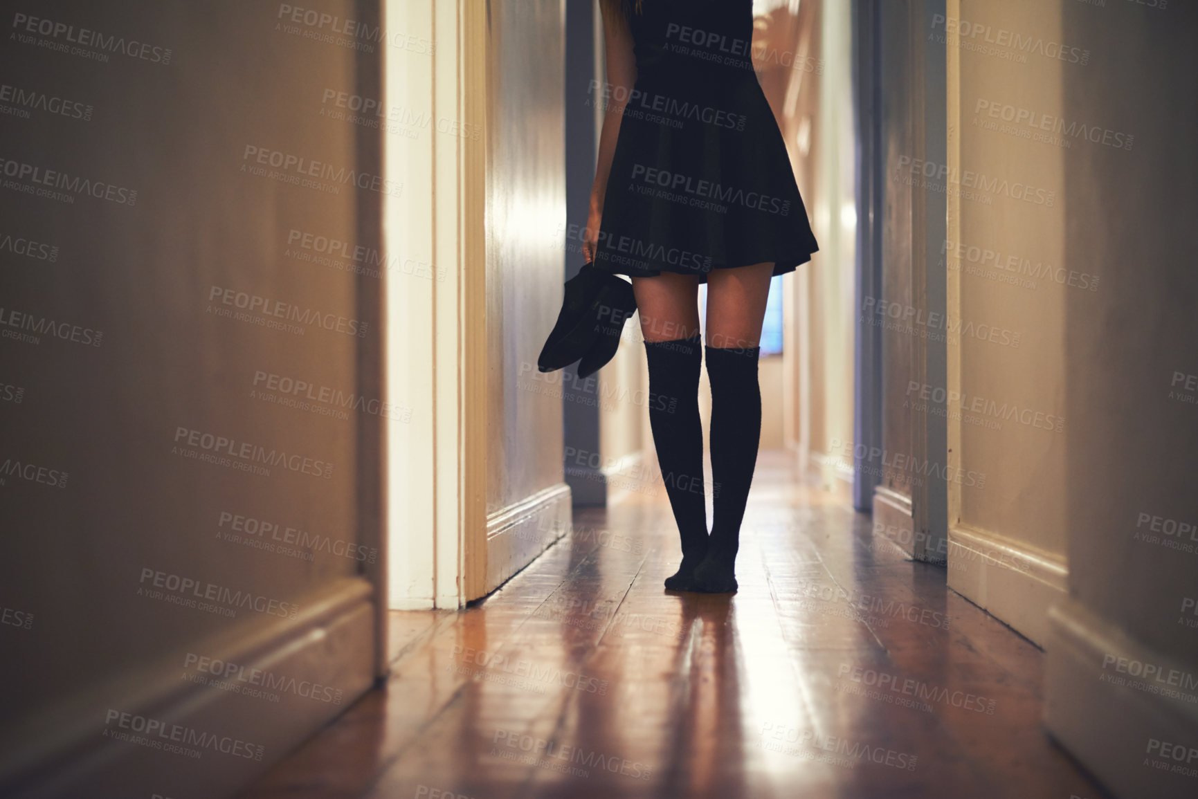 Buy stock photo Woman, legs and walking with shoes in hallway for fashion, clothing or outing at home. Closeup of young female person in dress and leggings by door for sneaking, silence or quiet foot steps at house