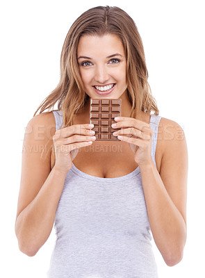 Buy stock photo Woman, eating chocolate and portrait with candy, face and pleasure for craving sugar in white background. Happy, snack and smile for comfort, dessert or sweets for calories, diet or tempting
