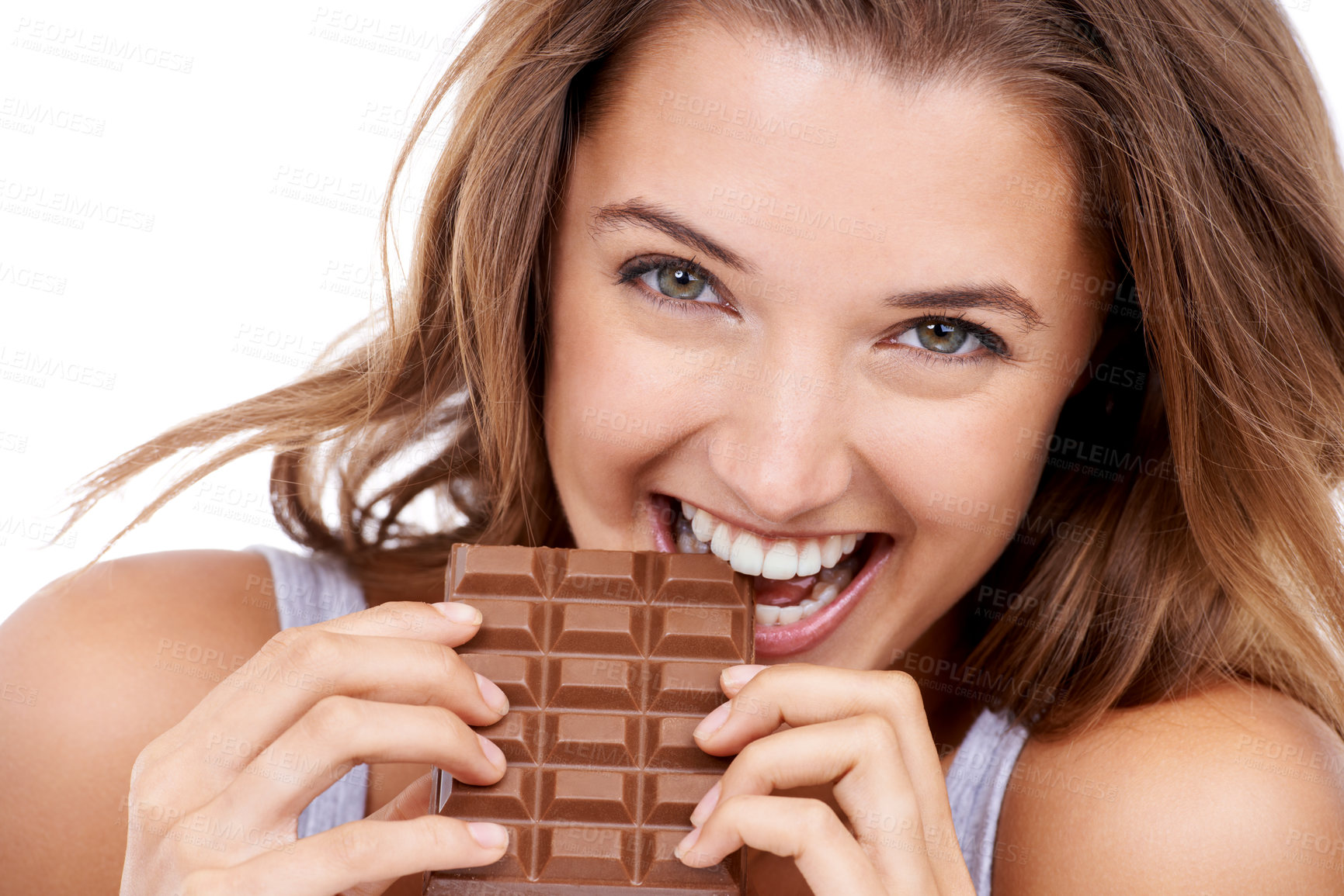 Buy stock photo Woman, eating chocolate and portrait, candy and sweet tooth with pleasure and craving sugar on studio background. Hungry, snack and meal for comfort, dessert and sweets for calories, diet and bite
