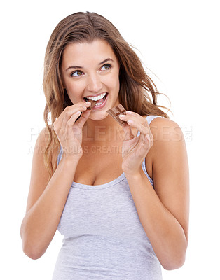 Buy stock photo Happy woman, eating chocolate and enjoy candy with sweet tooth, pleasure and craving sugar in studio background. Hungry, snack and meal for comfort, dessert and sweets for calories, diet and bite
