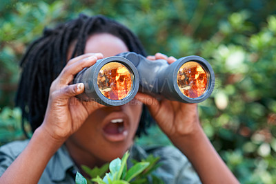 Buy stock photo A young boy looking through his binoculars