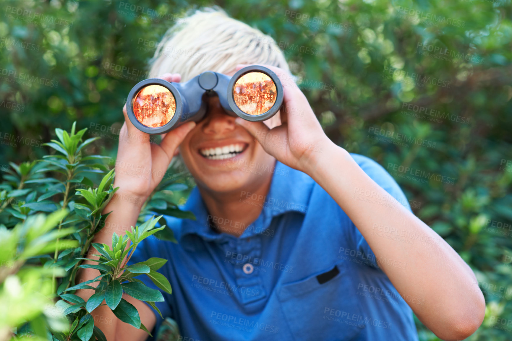 Buy stock photo Boy, child with binoculars and search in nature for learning and fun, forest and adventure at summer camp. Young camper, happy with leaves and explore environment outdoor for discovery and wildlife