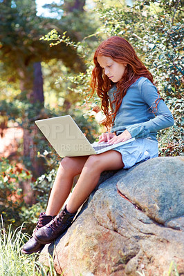 Buy stock photo Young girl, forest and laptop on rock for internet, break and connection on holiday in woods for travel tips. Child, red hair and computer on boulder for online research, camping and relax by trees