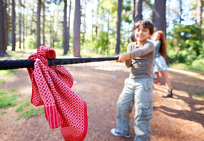Buy stock photo Kids, game and tug of war in forest at summer camp and holiday with travel and energy outdoor. Children with rope, adventure and team building with fun contest, playful and young friends in a park