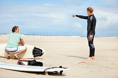 Buy stock photo Surfing, beach and men pointing with surfboard for water sports, fitness and exercise by ocean. Nature, friends and people with hand gesture for direction on holiday, vacation and adventure by sea