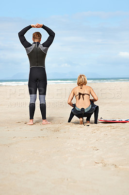 Buy stock photo Surfing, stretching and back of people on beach for water sports, fitness and exercise by ocean. Nature, friends and man and woman with surfboard for waves on holiday, vacation and adventure by sea