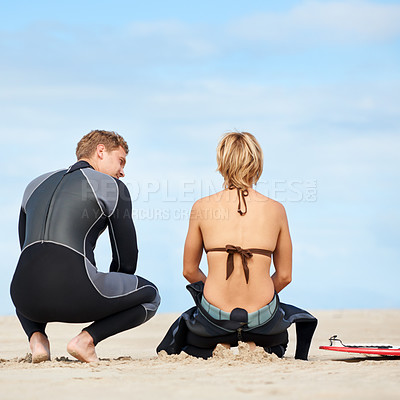 Buy stock photo Surfing, talking and back of people on beach with surfboard for water sports, fitness and exercise by ocean. Nature, friends and man and woman for direction on holiday, vacation and adventure by sea