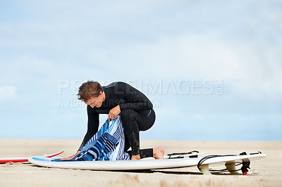 Buy stock photo Surfer, man and getting ready with surfboard in nature with wetsuit, blue sky or preparing with mock up space. Extreme sports, athlete and person outdoor for training, surfing workout or watersports 