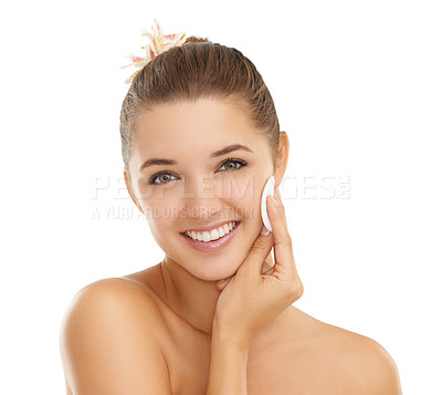 Buy stock photo Cropped portrait of a gorgeous young woman wiping her face with a cotton swab against a white background