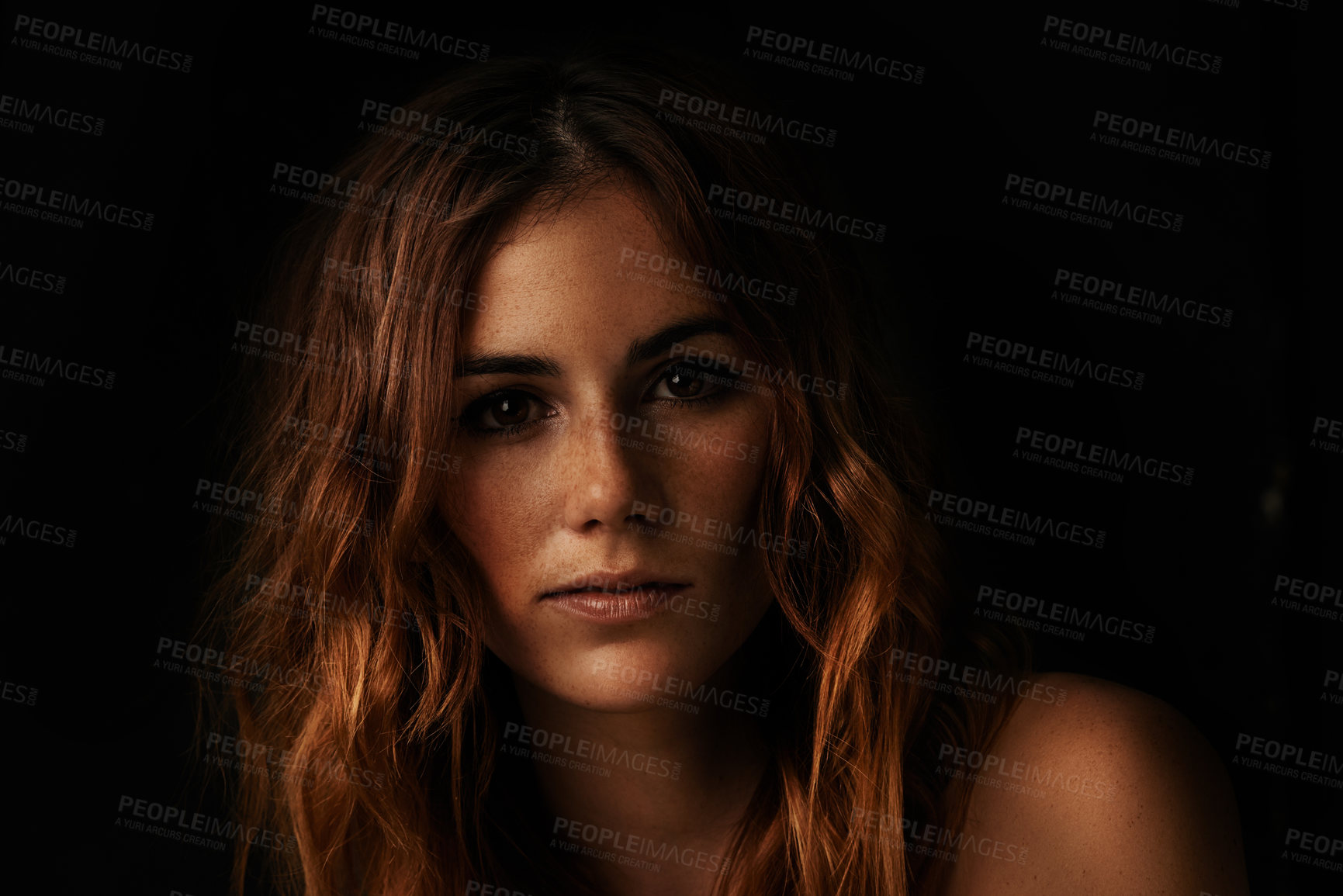 Buy stock photo Portrait of an attractive young woman in the dark