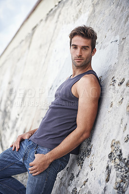 Buy stock photo Fashion, serious and portrait of man by rock in trendy clothes, casual style and outfit in nature. Masculine, sexy model and attractive person by wall with confidence, pride and stylish on weekend