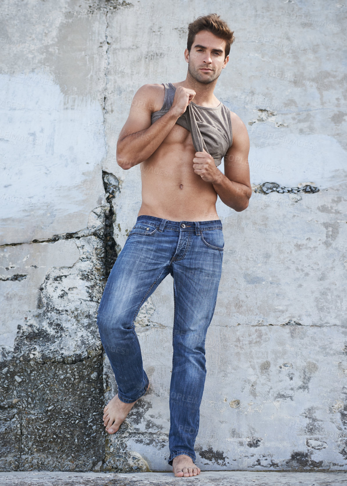 Buy stock photo Fashion, city and portrait of man by wall in trendy, casual and stylish outfit in nature. Serious, confidence and full length of attractive young male model undress with cool style by in town.