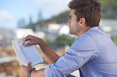 Buy stock photo Nature, story and young man reading for knowledge, fun or relaxing hobby on vacation or holiday. Travel, outdoor and handsome confident male person enjoying book or novel on weekend trip or adventure