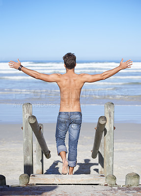 Buy stock photo Walking, arms up and back of man at the beach on tropical vacation, adventure or holiday. Travel, stairs and confident shirtless male person on outdoor steps by ocean or sea for summer weekend trip.