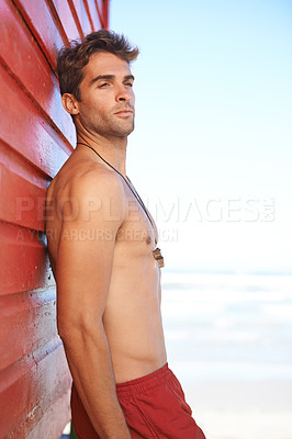 Buy stock photo Man, lifeguard and relax at beach for security, emergency or help in surveillance or monitoring safety at bay. Male person, athlete or professional swimmer ready to assist on mockup space at ocean