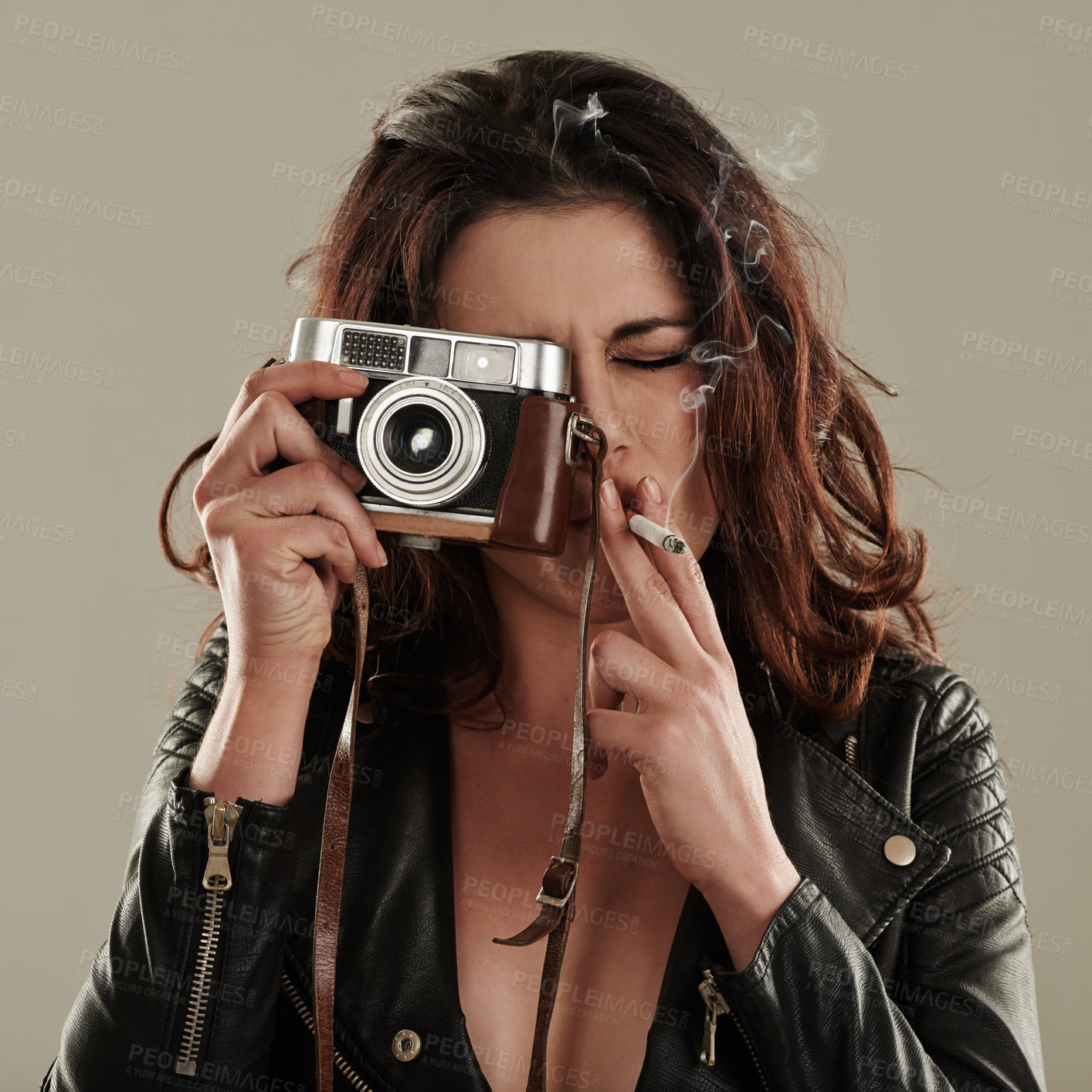 Buy stock photo Photographer, woman or smoking a cigarette with fashion, confidence or beauty on grey studio background. Camera, person or model with tobacco or stylish outfit with bad habit or picture with nicotine